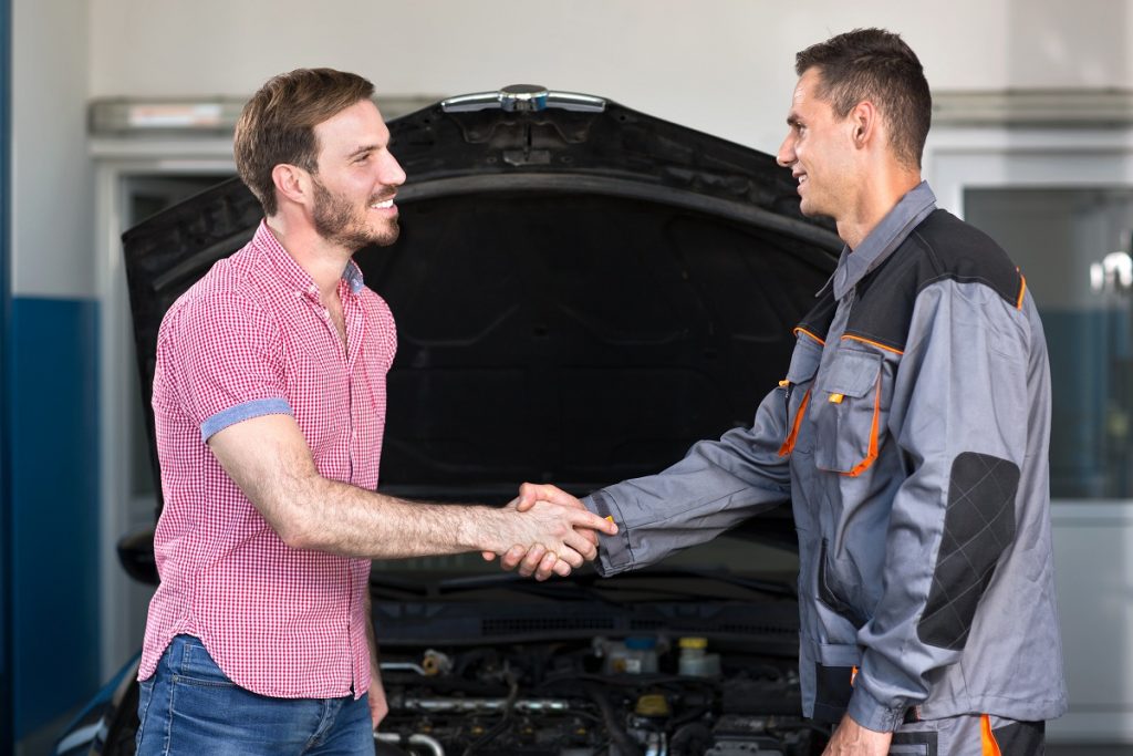 Mechanic and customer handshake