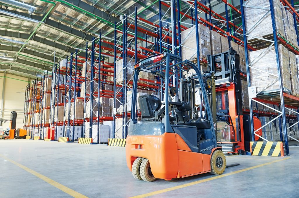 Forklift loader and steel racks inside the warehouse