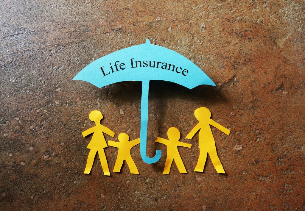 Life insurance umbrella under paper cut family