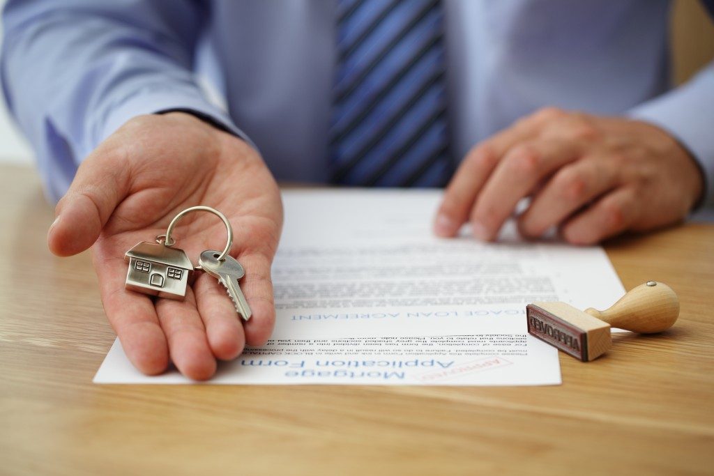 man holding keys to new house