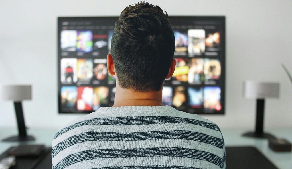 man searching for a movie to watch