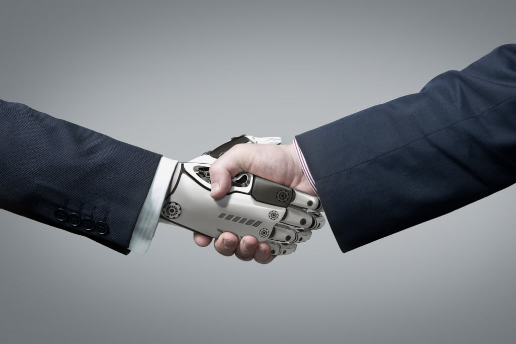 artificial intelligence concept human hand shaking robot hand