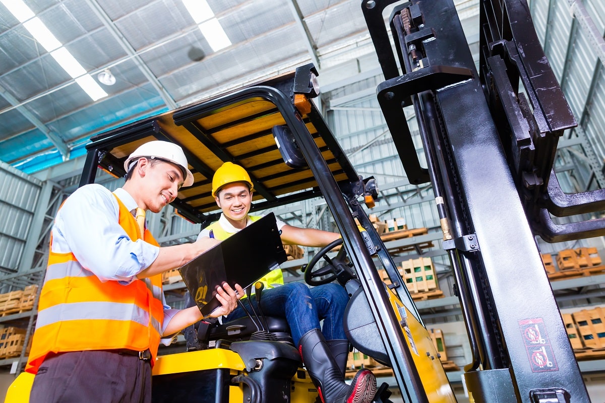 forklift driver and foreman in a warehouse